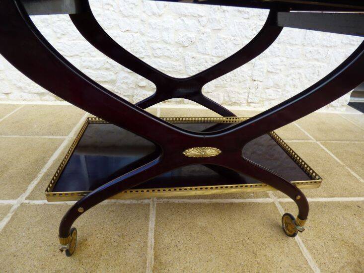 Chic serving table on wheels from the 60s with brass decorations and two shelves.