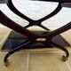 Chic serving table on wheels from the 60s with brass decorations and two shelves.