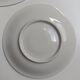 Solitaire tea cup, saucer, and dessert plate in white and gold.
