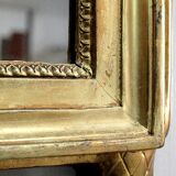 Miroir en bois doré, style Louis XVl, début XXe