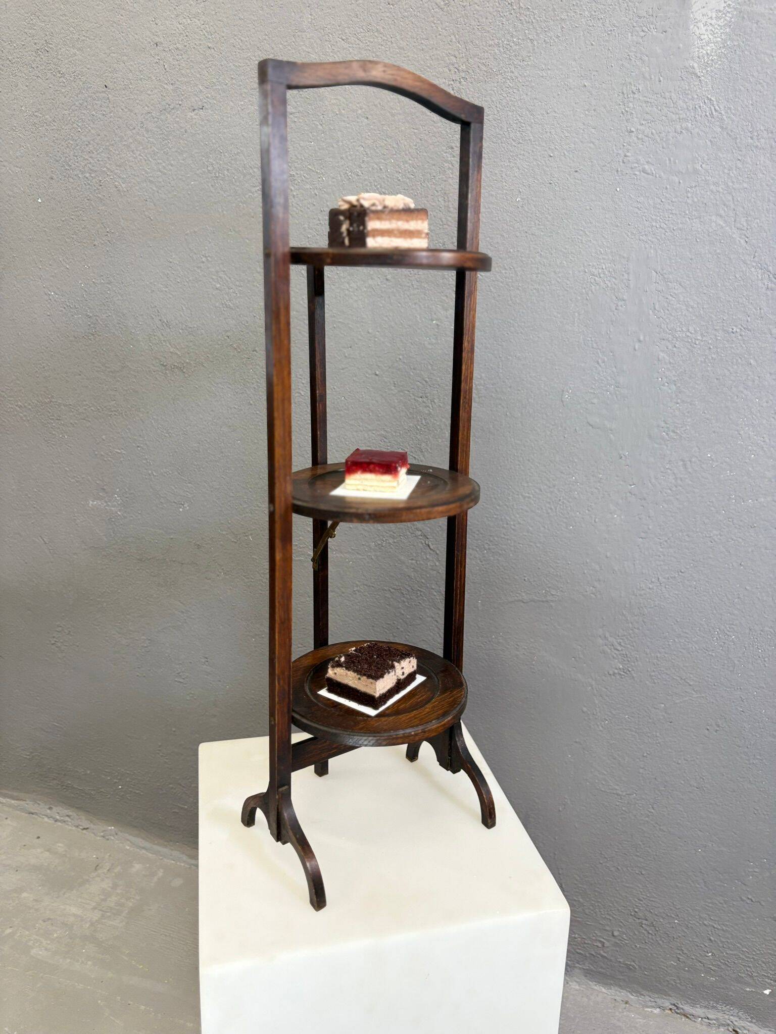 Vintage 3-tier cake stand in dark wood, 1920s serving display.
