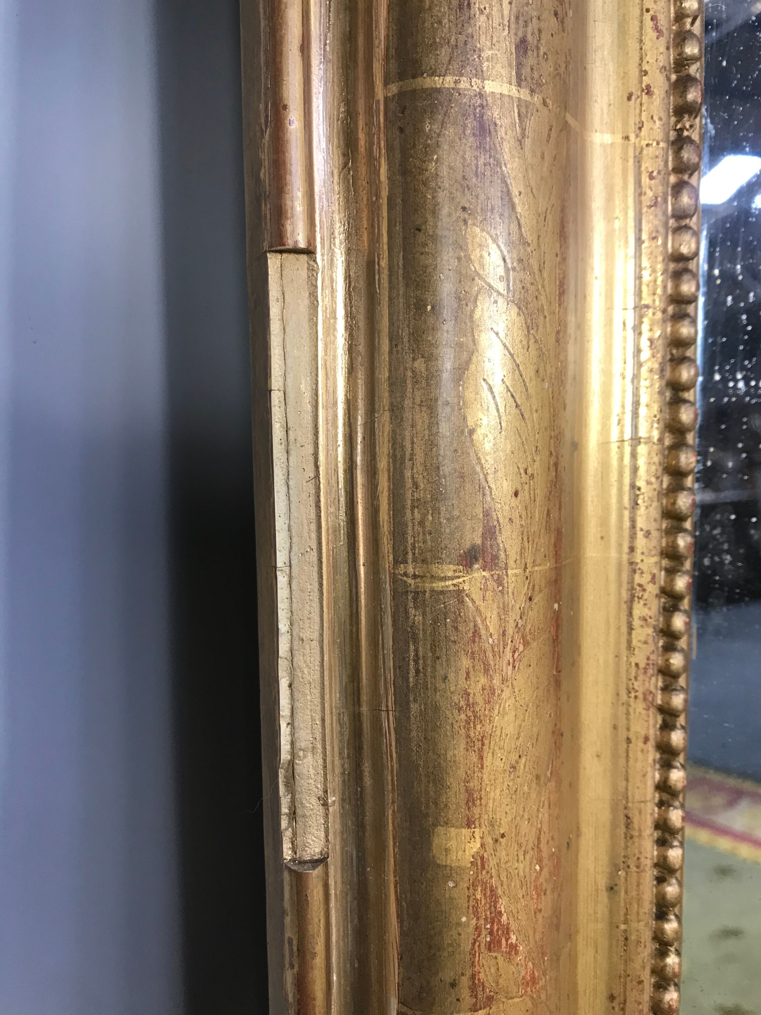 Louis Philippe's era mirror with a gold leaf pediment