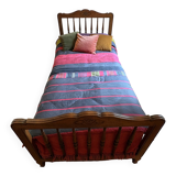 1 bed with a wooden frame and mattress