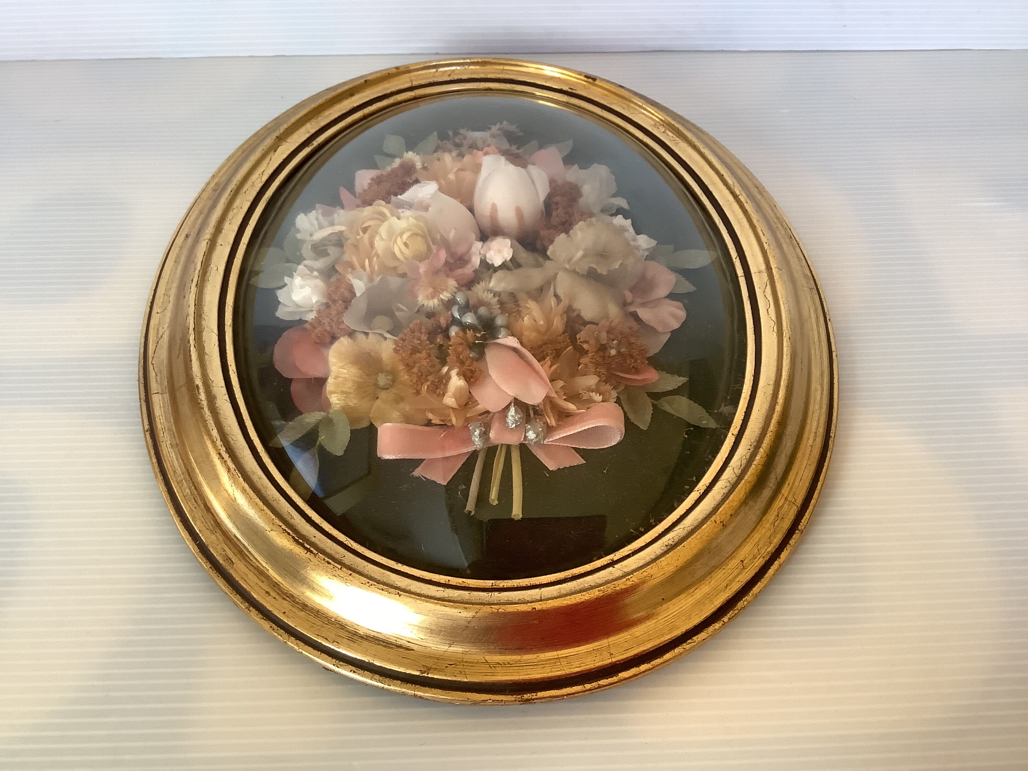 Golden oval frame dried flowers