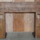 Antique fireplace from around 1880 in solid hand-carved elm with openwork columns.
