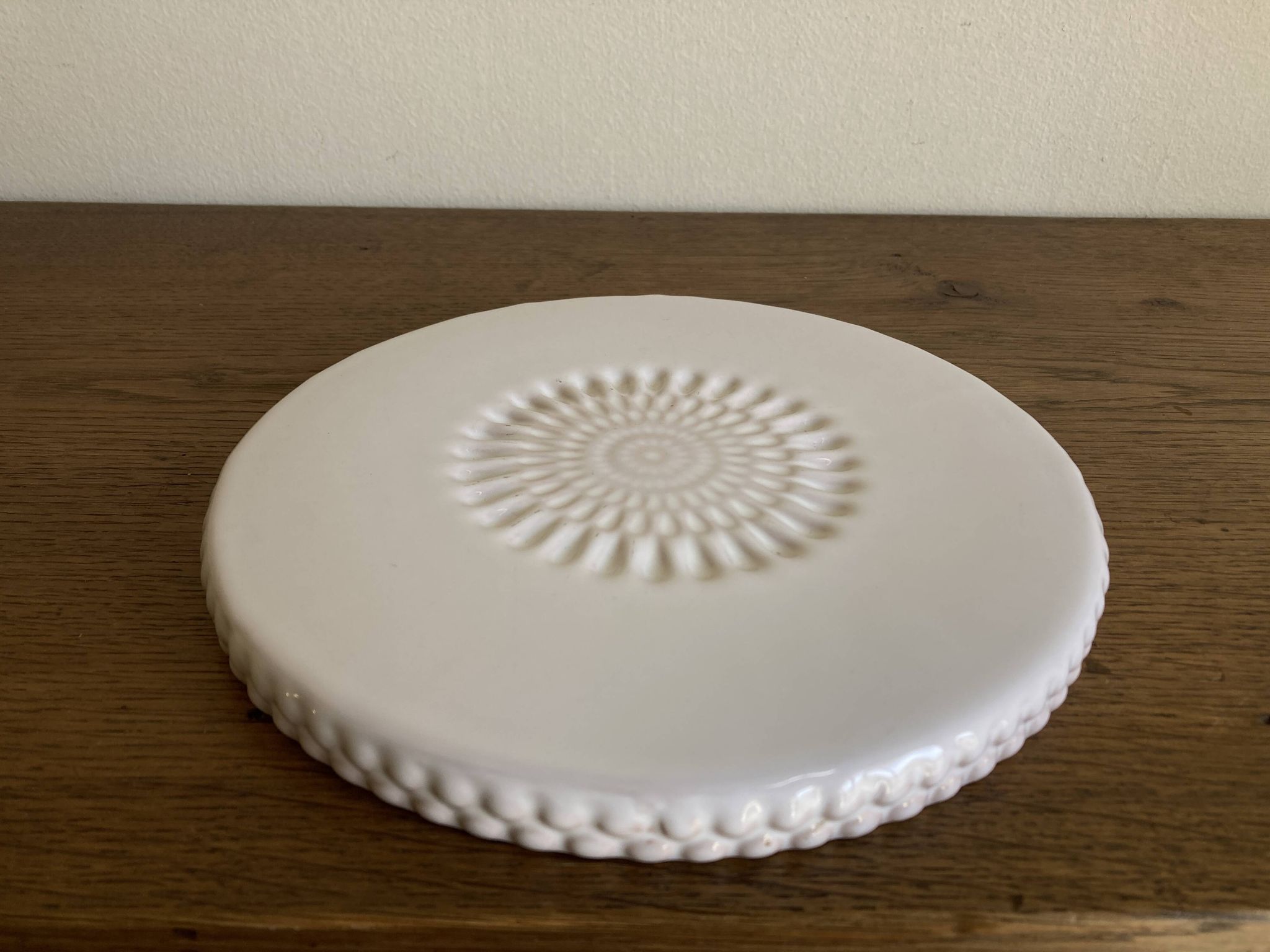Pierre Motton glazed earthenware scalloped trivet for Gien