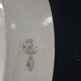 Large antique plate stamped with a fauna and flora pattern.