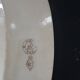 Large antique plate stamped with a fauna and flora pattern.