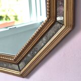 Antique mirror with gilded wooden frame.