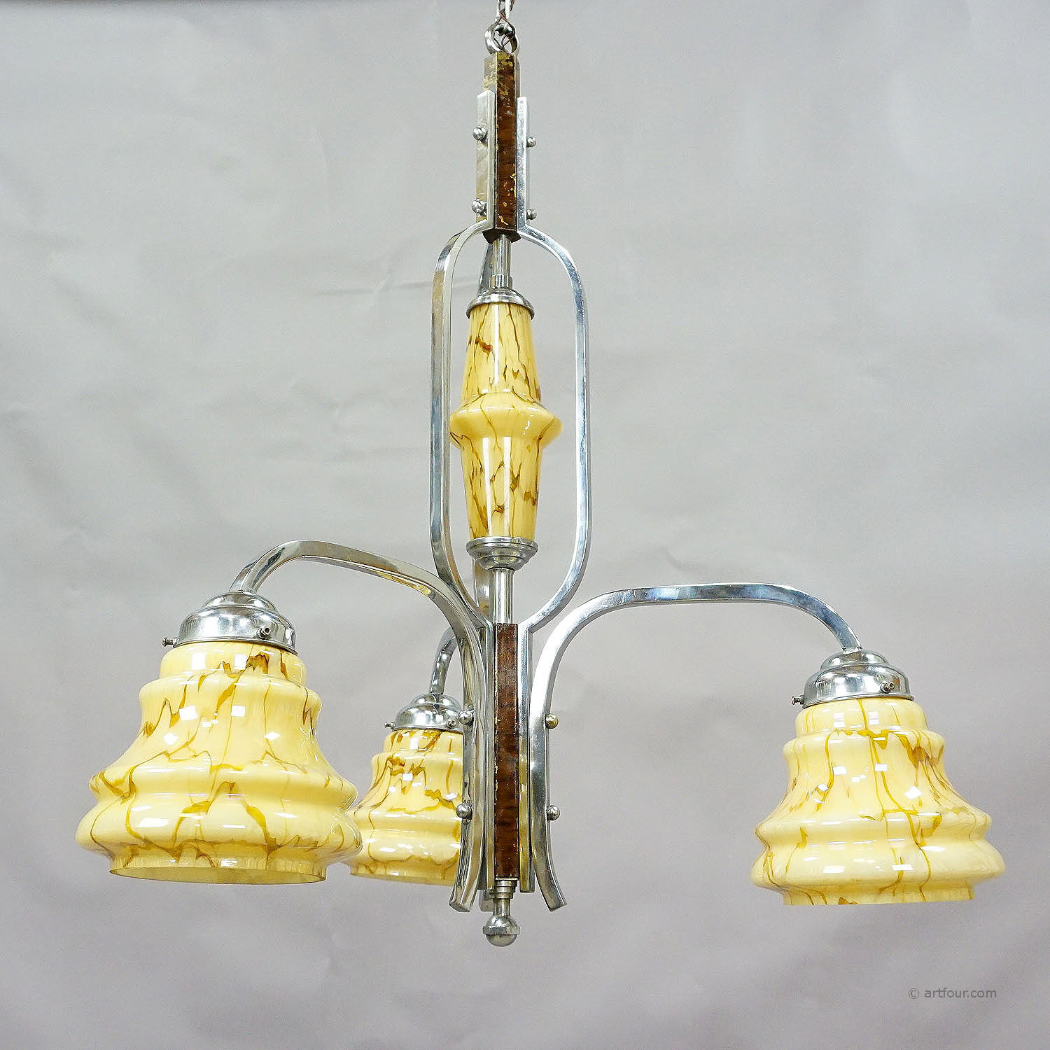 Antique Art Deco chandelier with three glass lampshades.