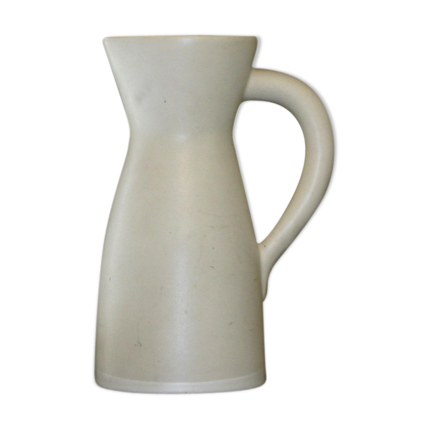 White ceramic pitcher with green background