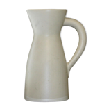 White ceramic pitcher with green background