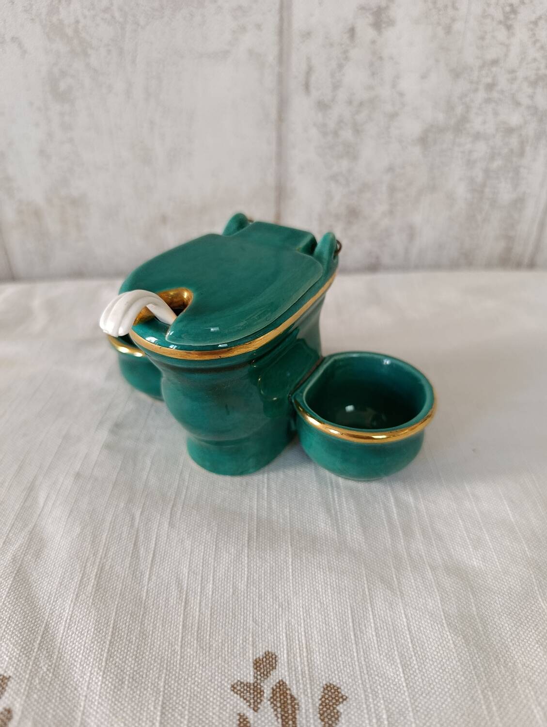 Mustard and salt pepper shaker in the shape of a toilet.