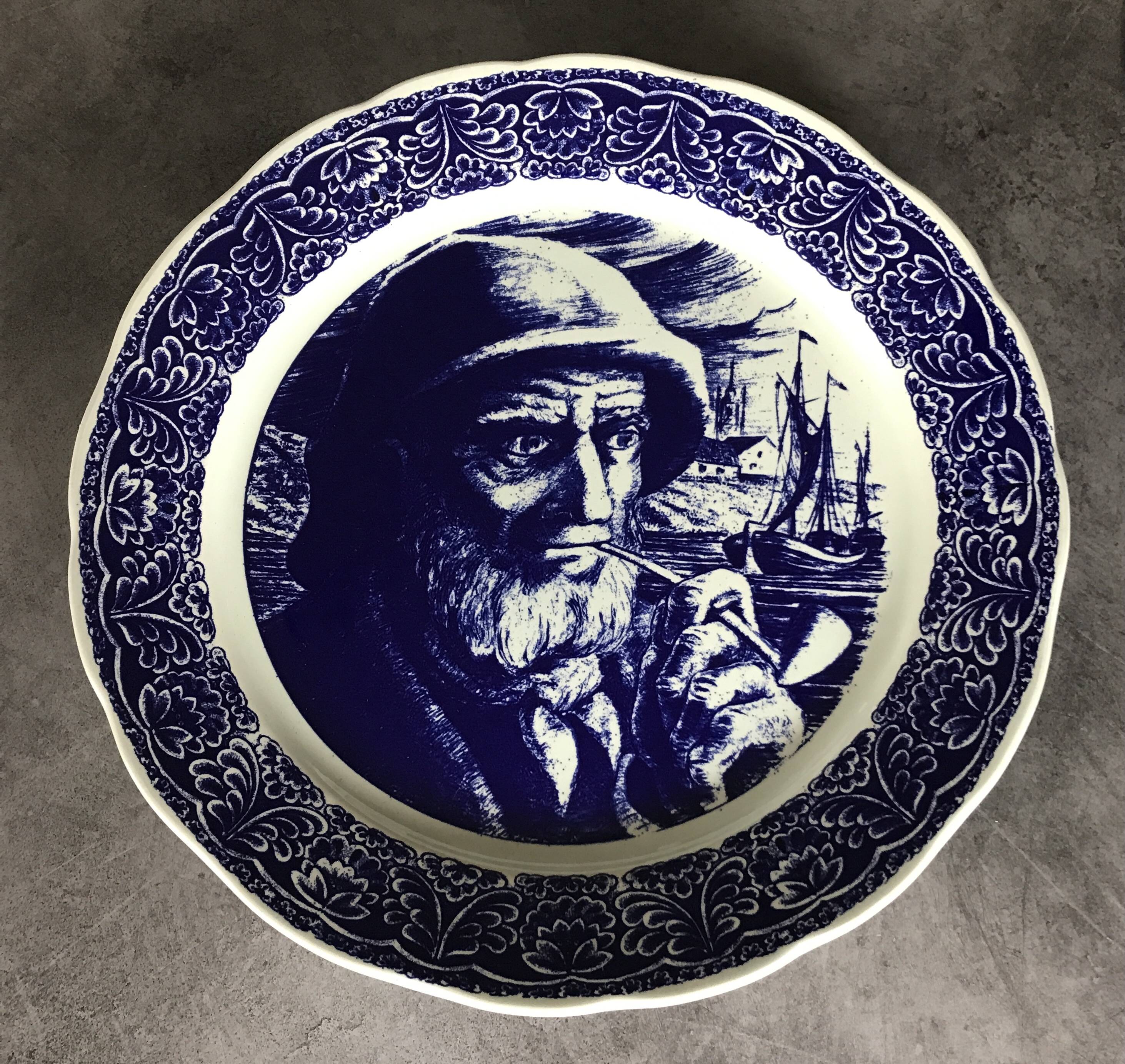 Blue enamelled earthenware wall plate with fisherman decor, Boch La Louvière, Belgium