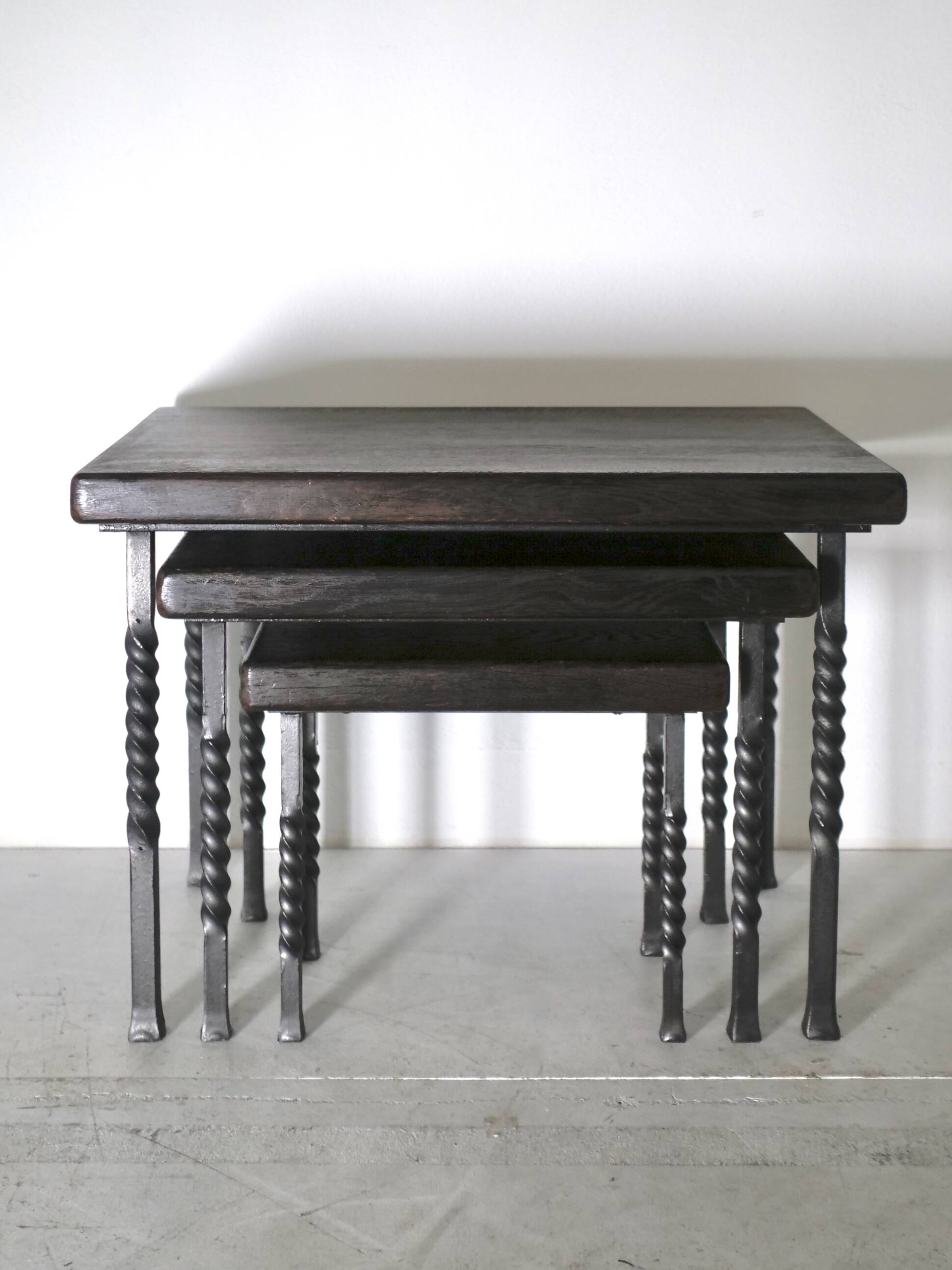 Brutalist nesting table in ebonized oak and wrought iron