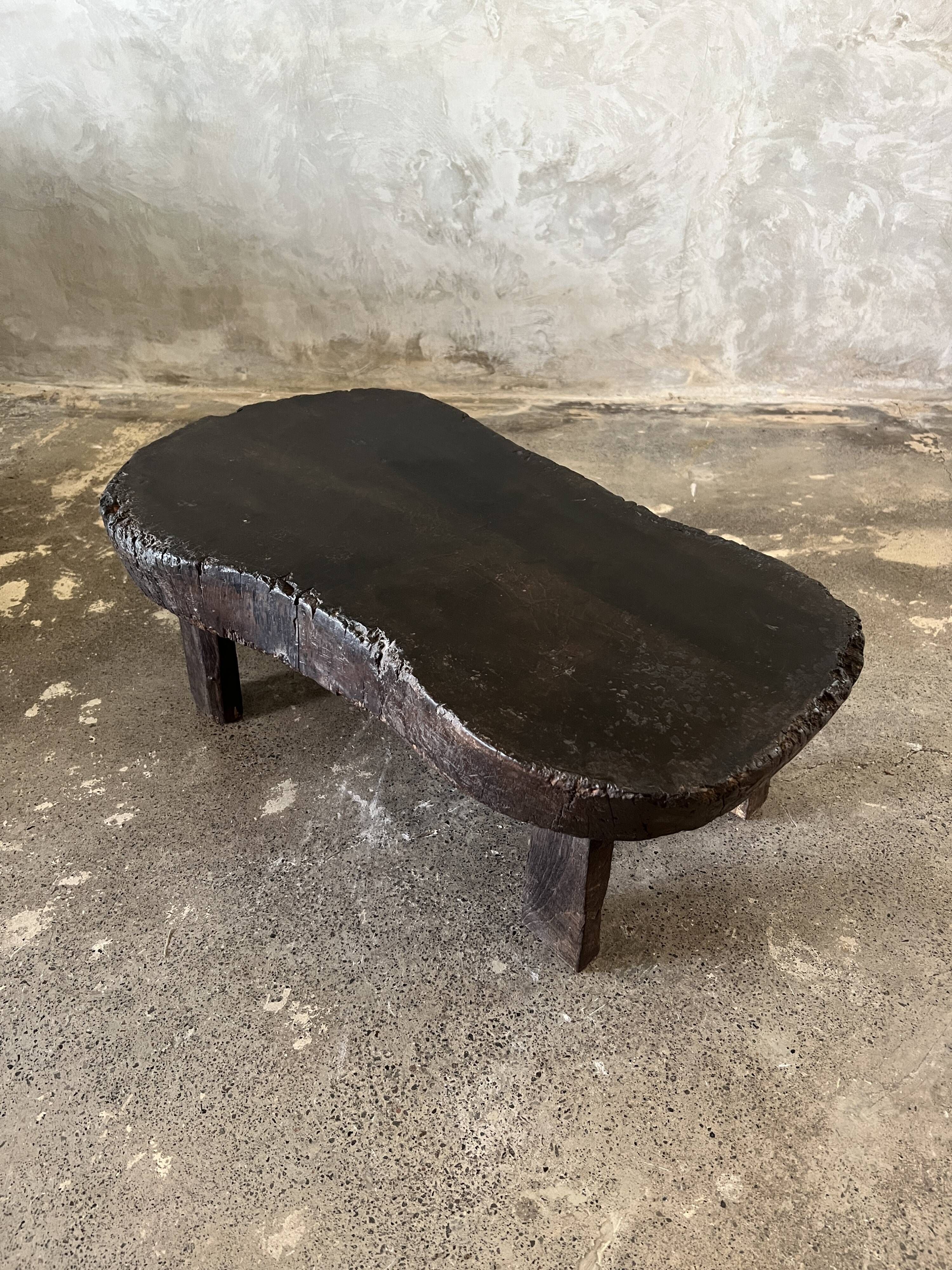Small old Asian wooden coffee table in Japanese style, kidney-shaped top