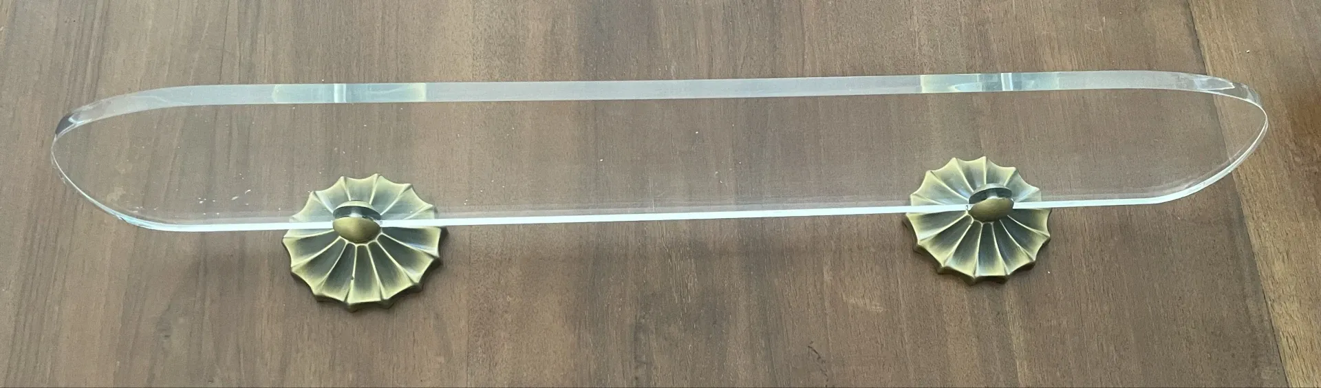 Vintage lucite and brass shelf with its hooks.