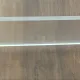 Vintage lucite and brass shelf with its hooks.