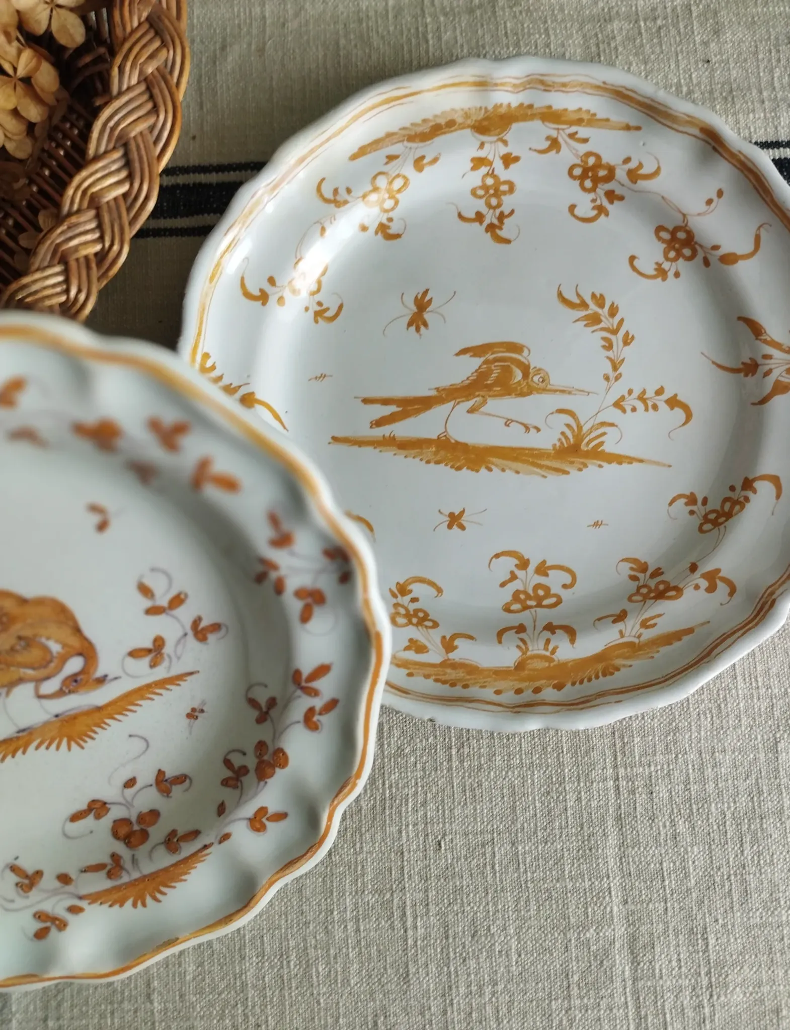 Pair of antique plates with a bird of paradise design in the style of Moustiers.