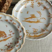 Pair of antique plates with a bird of paradise design in the style of Moustiers.