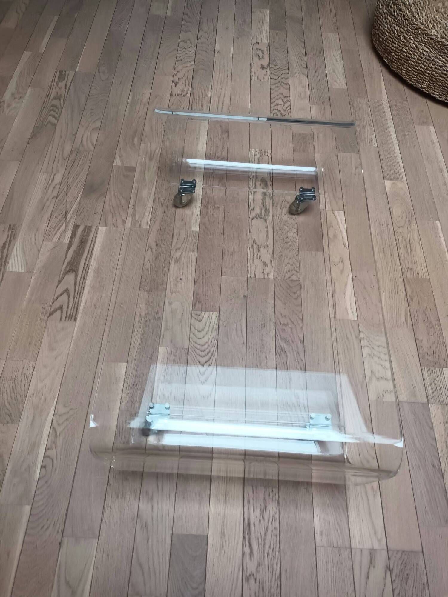 Design coffee table from Habitat in transparent plexiglass, mounted on wheels.
