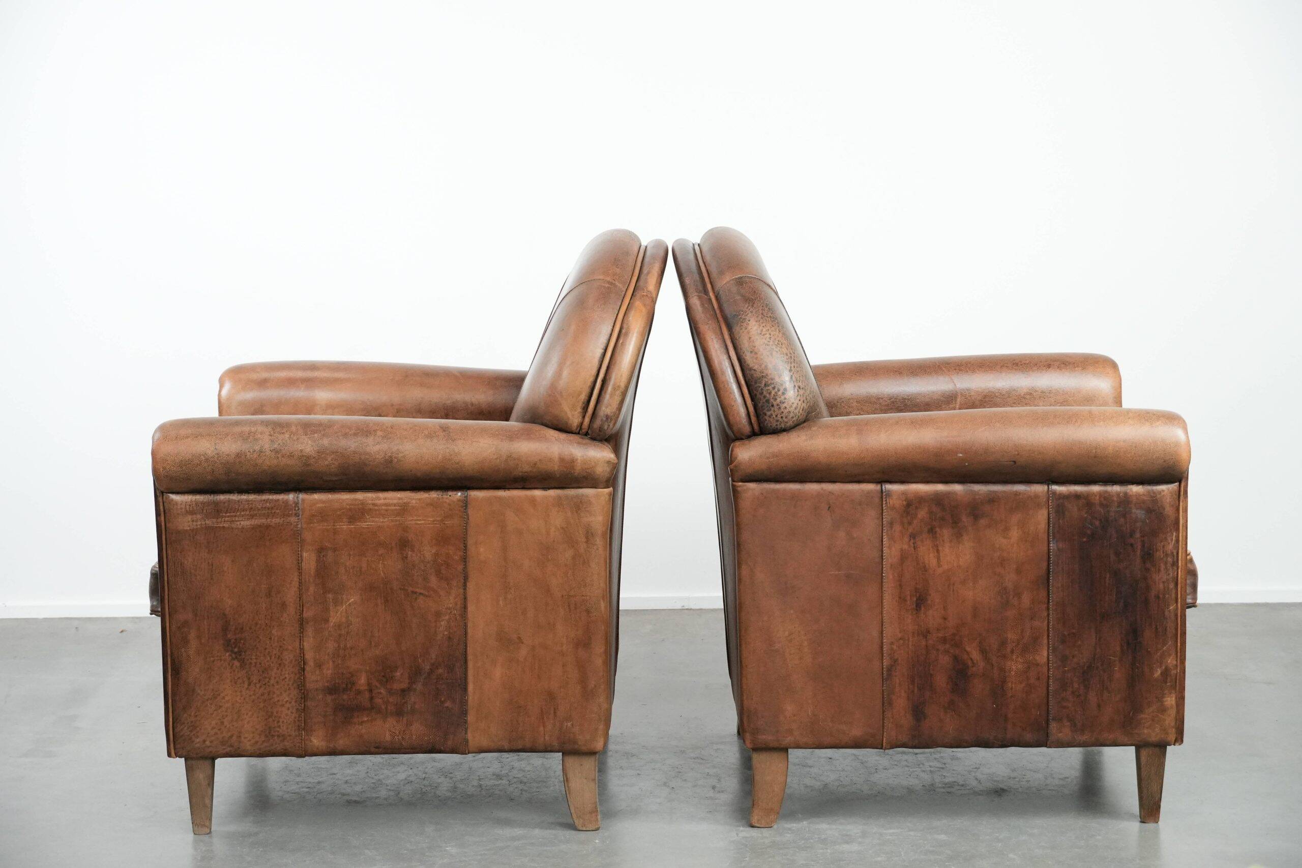 Set of 2 vintage sheepskin armchairs with a characterful appearance