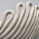 Draped ceramic wall light in a half-moon shape.