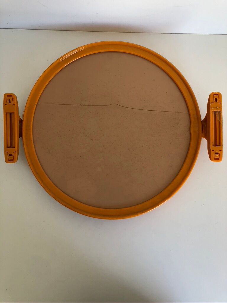 Tiltable orange plastic mirror with matching wall light
