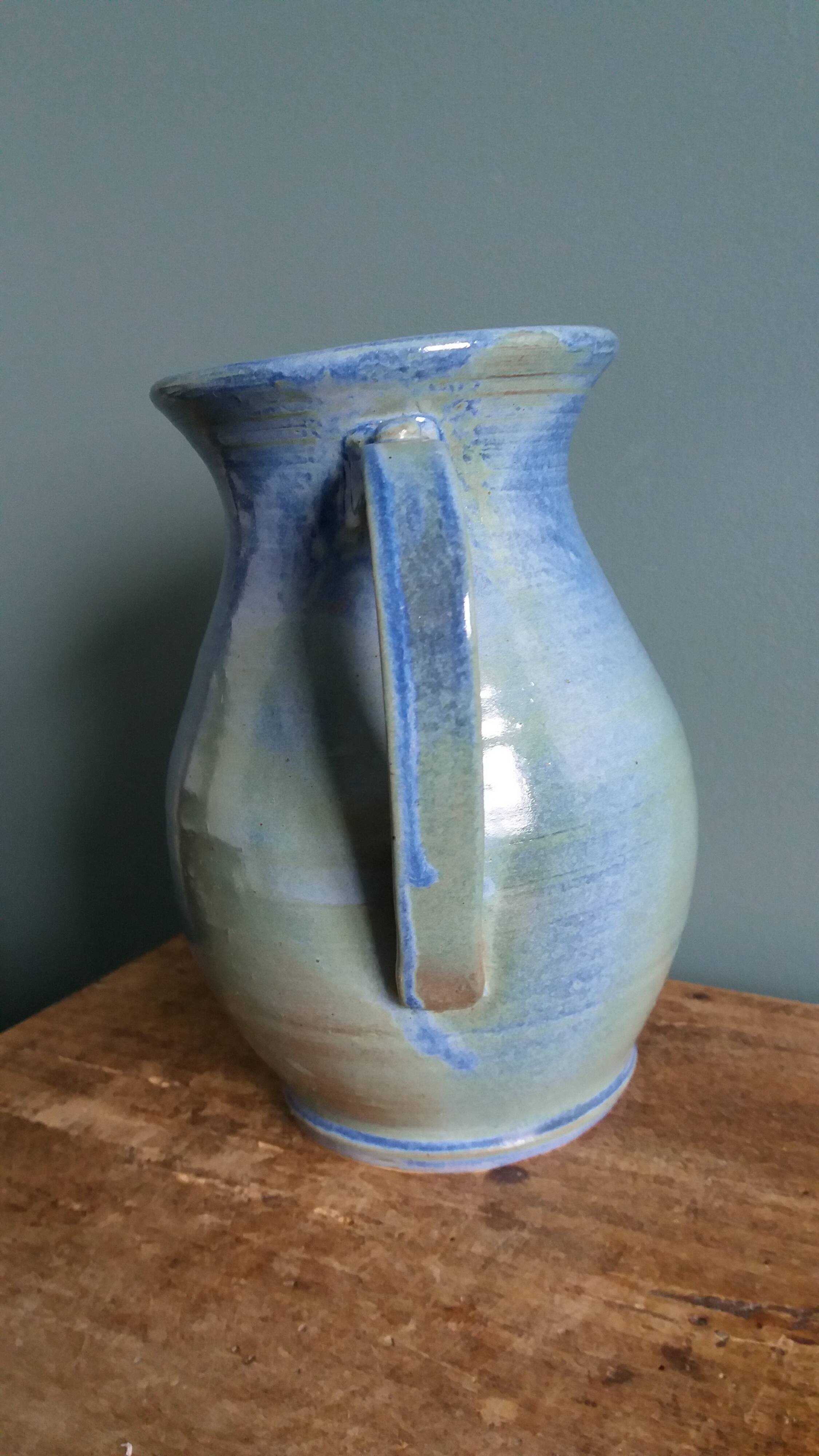Enamel pitcher in pastel blue and green, signed