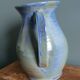 Enamel pitcher in pastel blue and green, signed