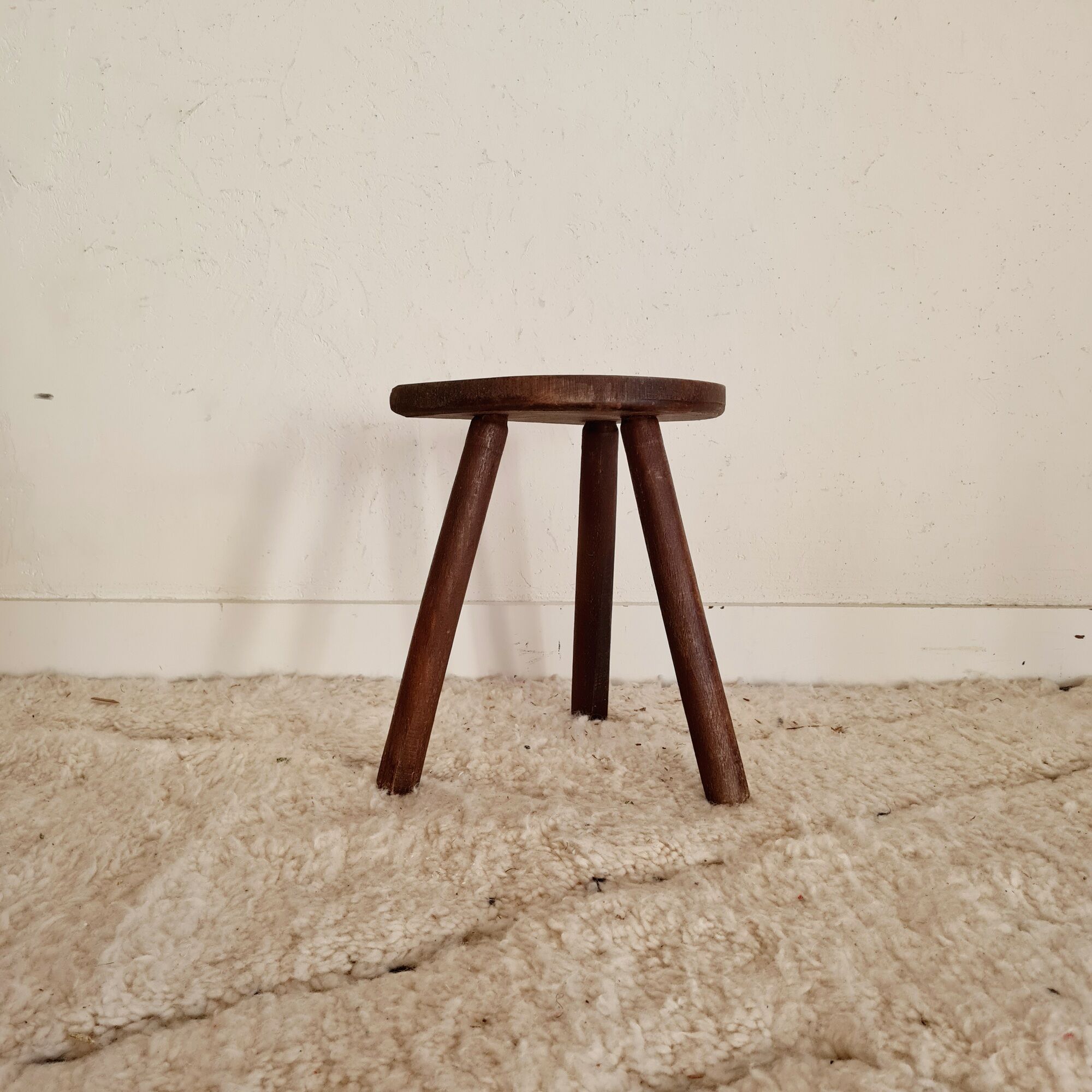 Old wooden tripod wooden farm stool made of wood