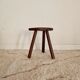 Old wooden tripod wooden farm stool made of wood