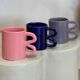 Ceramic mug with wave handle
