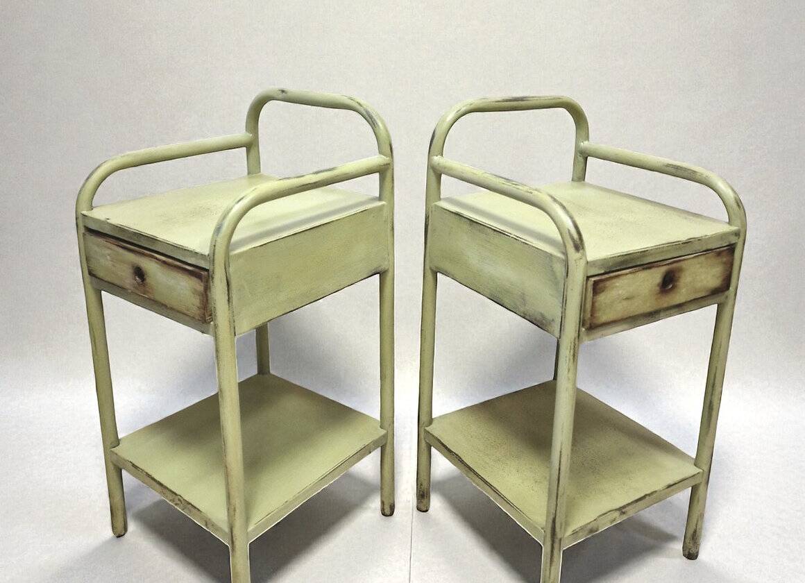 Copy of a pair of patinated metal bedside tables.
