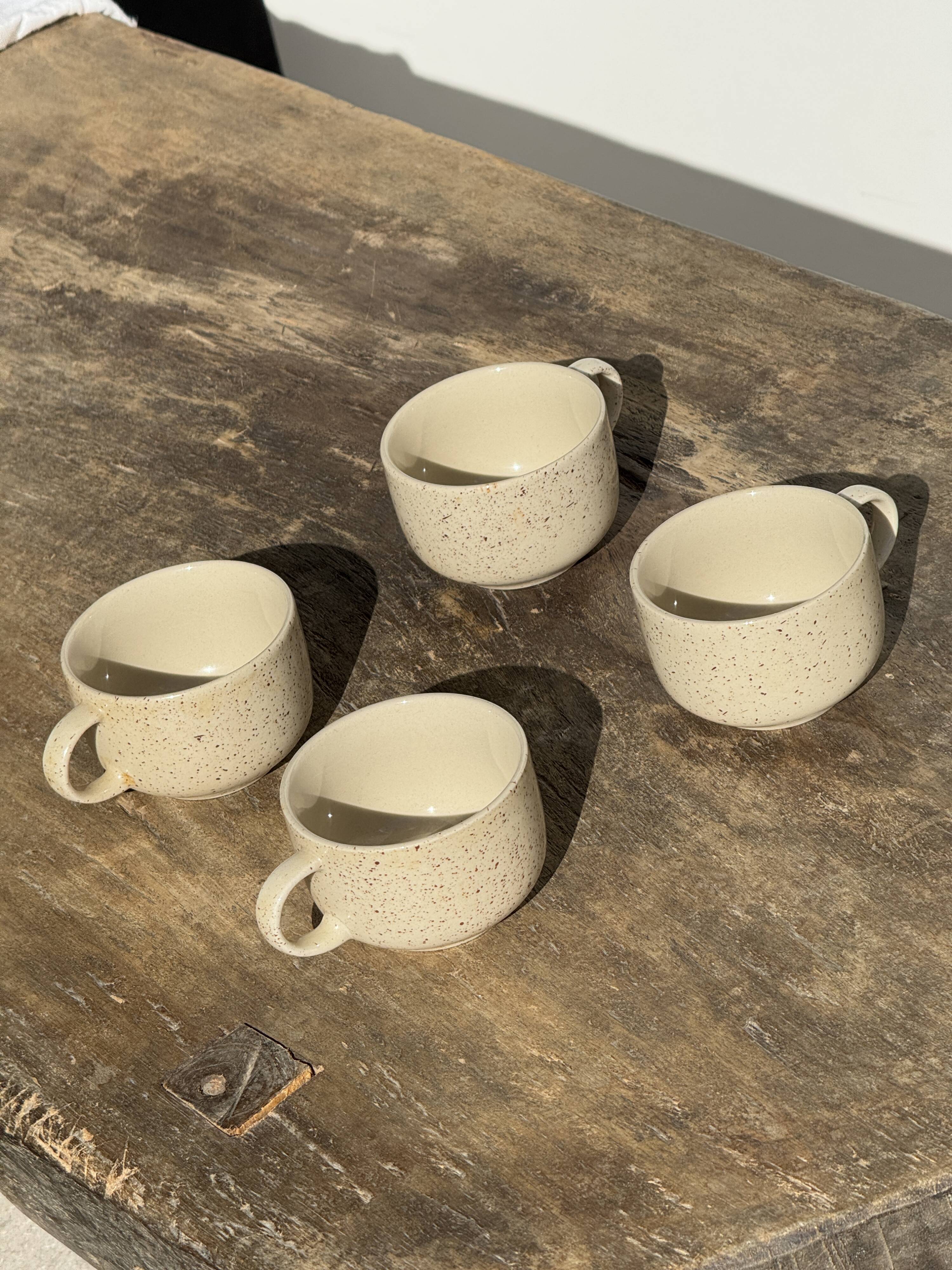 Set of 4 vintage speckled beige stoneware coffee cups.