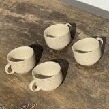 Set of 4 vintage speckled beige stoneware coffee cups.