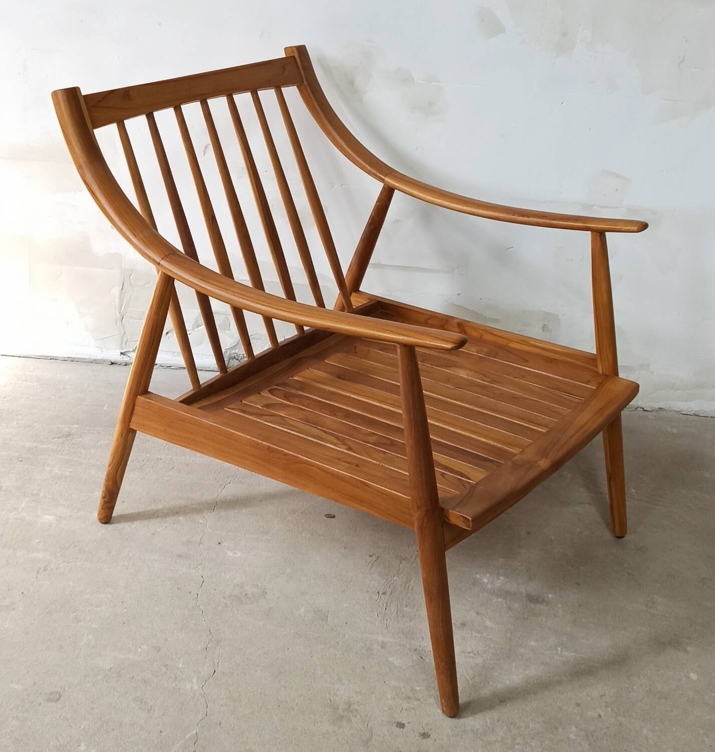 Pair of cozy teak armchairs with cushions