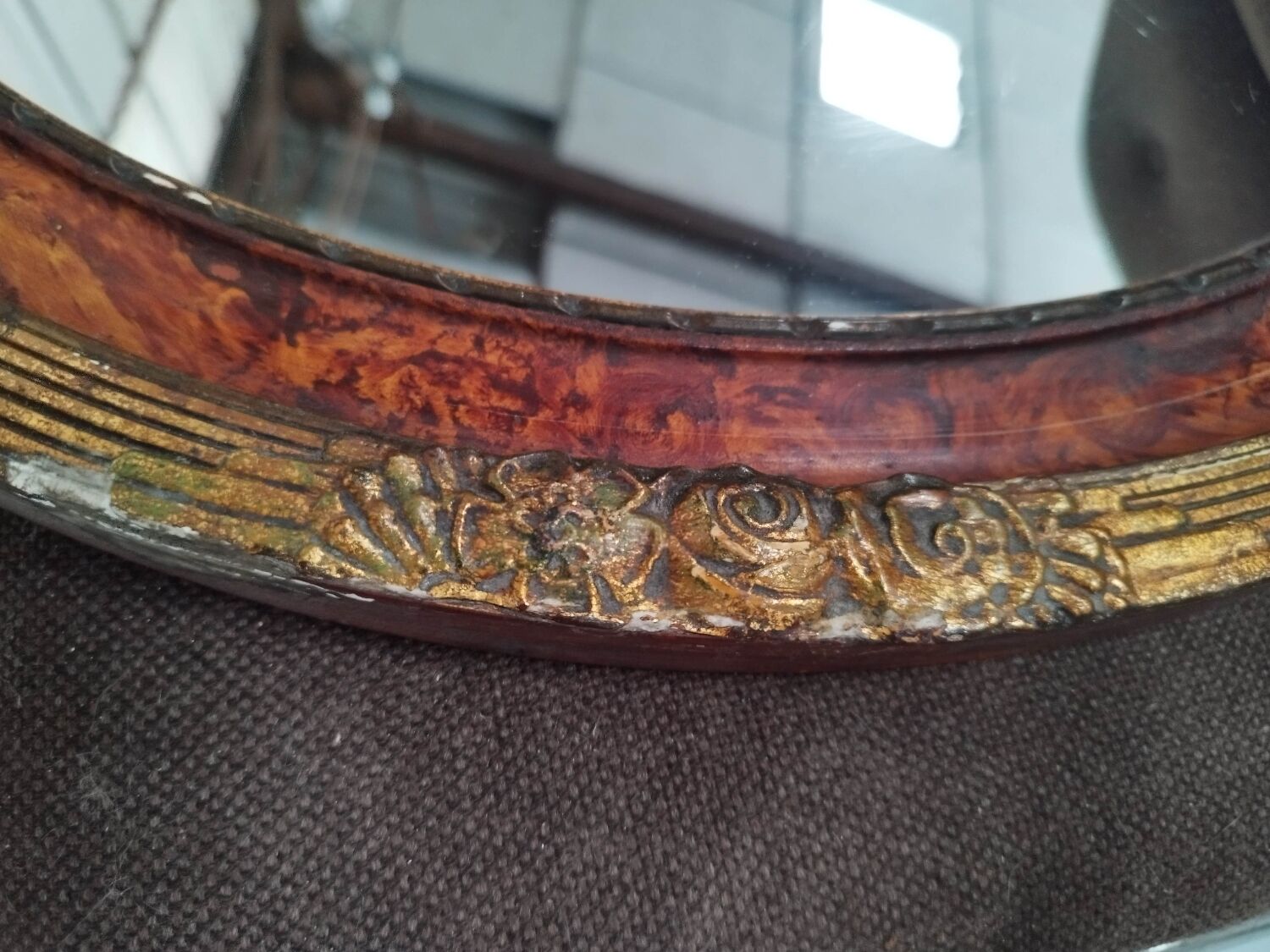 Golden oval art deco mirror