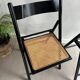 Vintage folding chairs in black wood and cane.