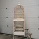 Double cage with birds in wooden metal white rectangular bell tower 1910