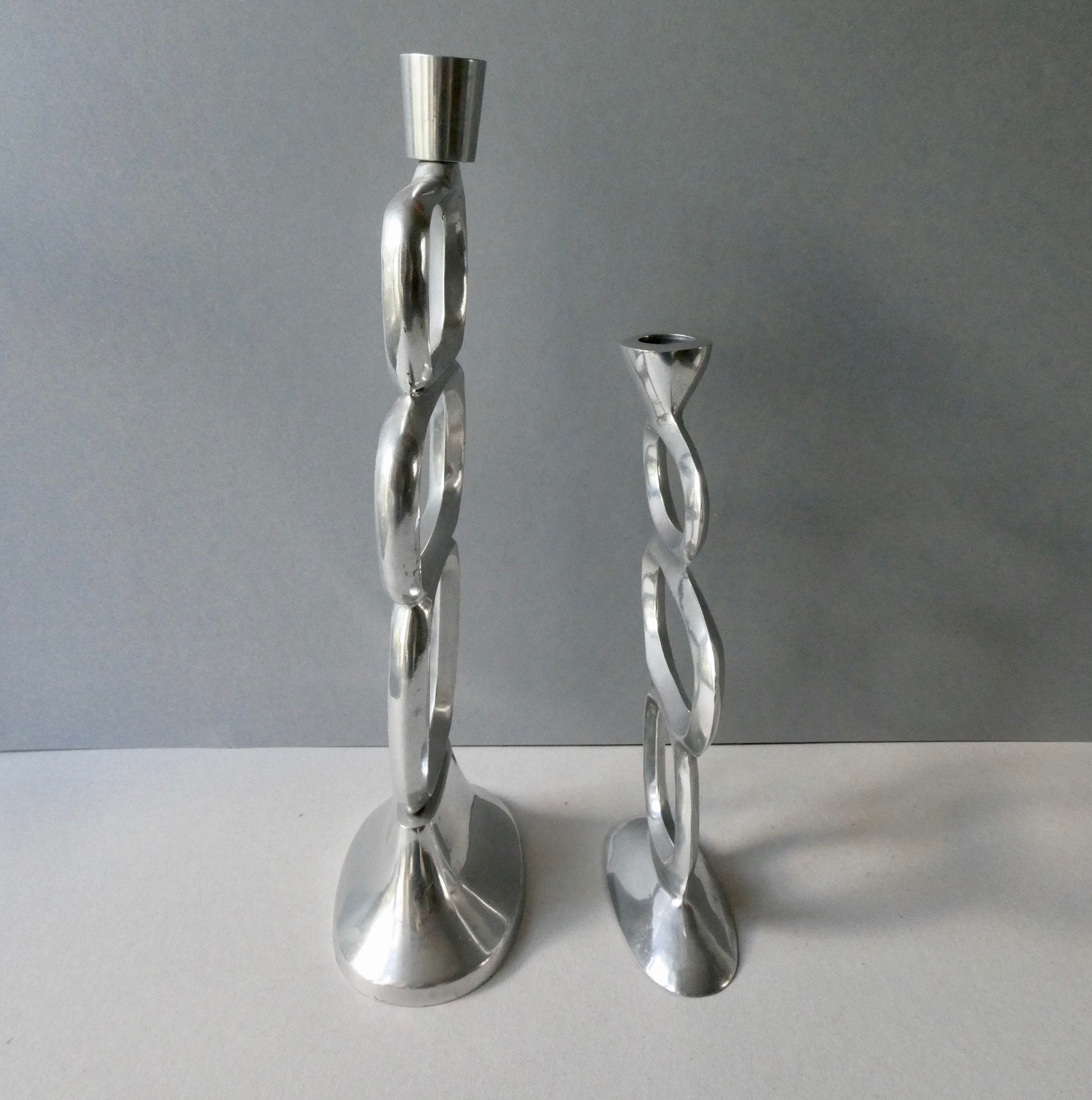 Pair of cast aluminum candle holders, design