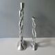 Pair of cast aluminum candle holders, design