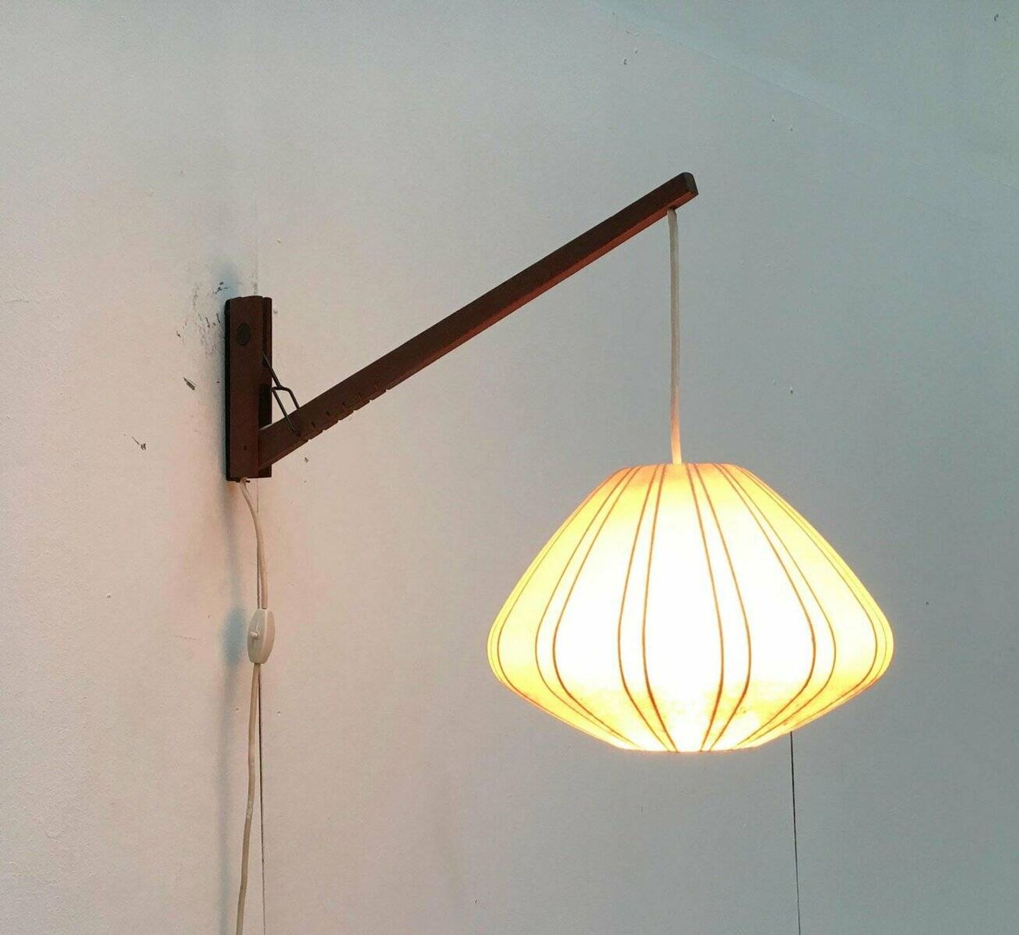 Mid-century pivoting wall lamp with a swing arm, Cocoon, made of teak wood, 1960s.