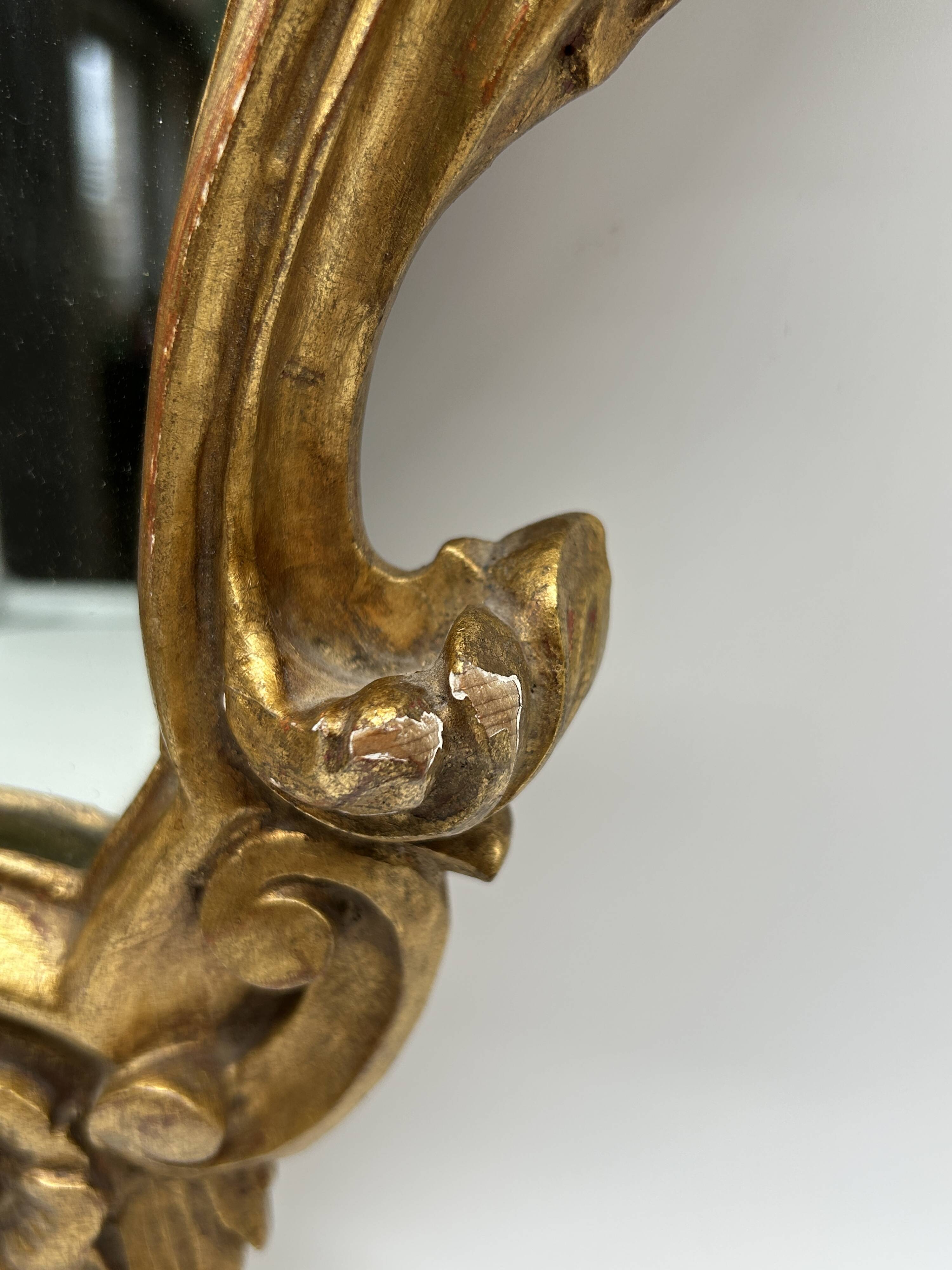 Wooden mirror with gilded stucco