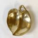 Brass catchall in the shape of an apple.