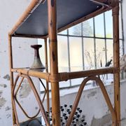 Rattan bookshelf and black glasses