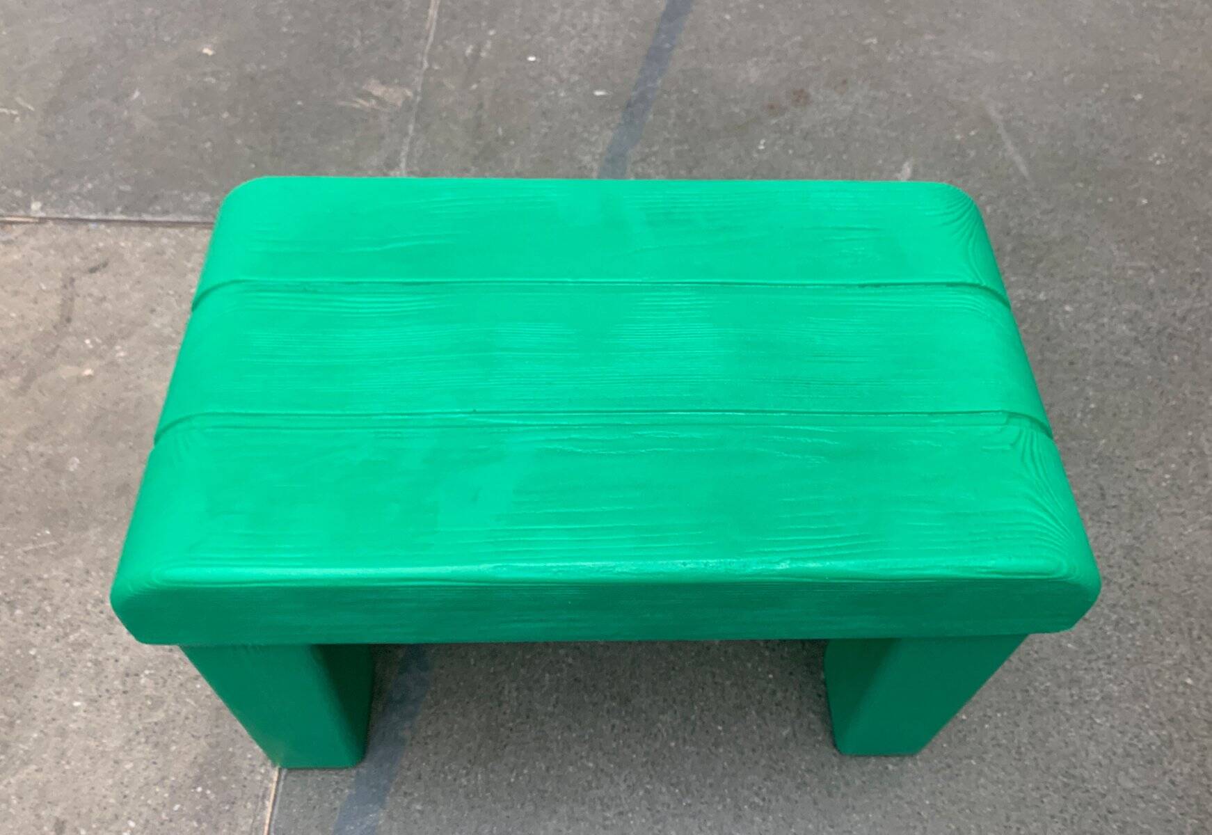 Postmodern plastic stool with a wood effect.
