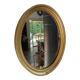 Oval mirror in gilded wood