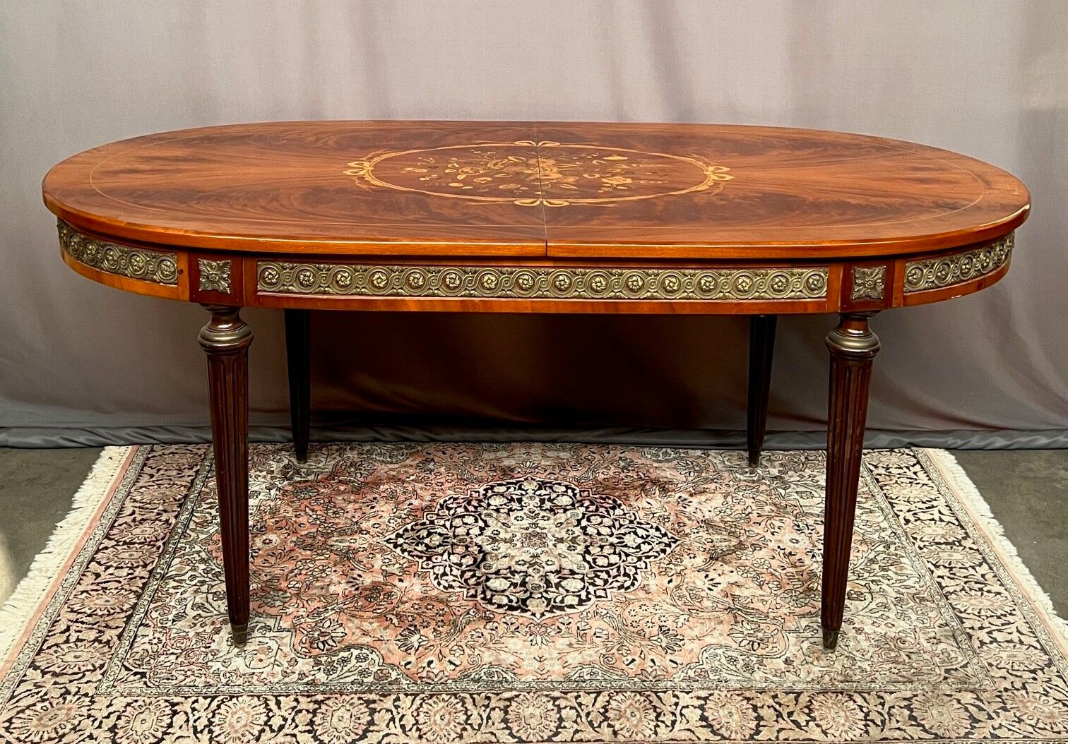 Louis XVI style oval dining table with rosewood marquetry extension mounted in bronze