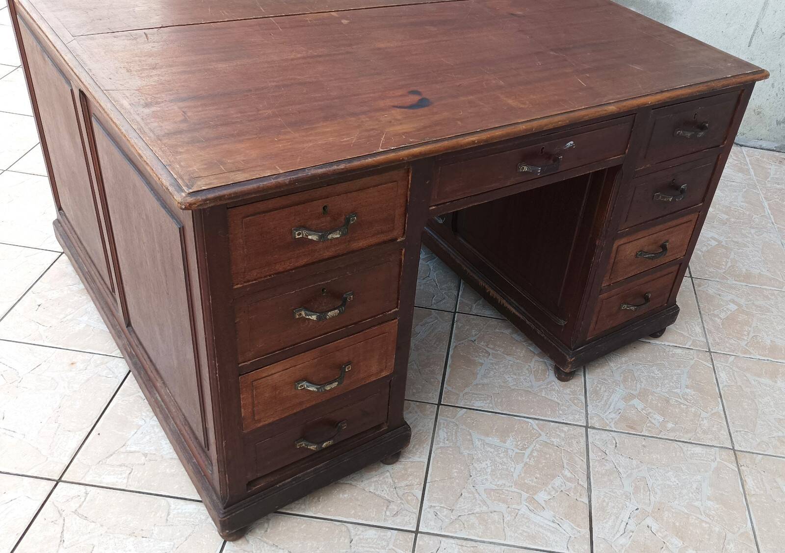 Vintage double-sided mahogany desk with 18 drawers.